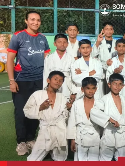 Young judo athletes and their coach pose for a photo after a successful Inter School Judo Championship.