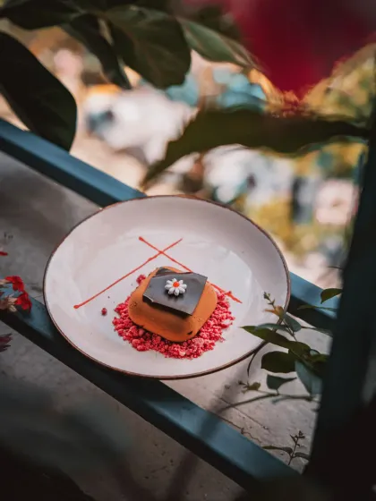 Chocolate and Cherry Desire, a love letter in dessert form. Dark Valrhona mousse melts into sour cherry with a playful crunch.