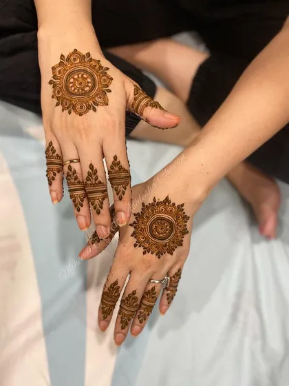 A modern mandala design with detailed finger work. This is a great choice for someone who wants a stylish and contemporary mehendi look.