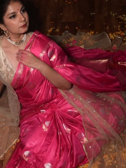 A graceful pose in a beautiful pink saree, surrounded by flower petals. This shot is part of an artistic collaboration celebrating the colors and emotions of Holi.