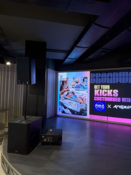 A side view of the stage at our Delhi event, showing the integration of speakers and a large digital display. We ensure every technical detail is handled for a smooth activation.