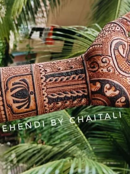 A semi bridal design with a mix of traditional Indian motifs. You can see the peacock on the palm and the architectural dome on the wrist, all drawn with neat, clean lines.