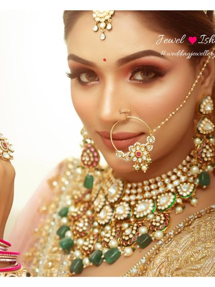 A close-up shot focusing on the beautiful Polki and ruby nath and the layered choker with green beads. This shows how different colored stones can be mixed.