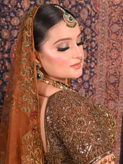 Eyes closed, the focus shifts to the stunning glitter eyeshadow. This shot is perfect for showing the detail and artistry of the eye makeup, a key part of any bridal look.