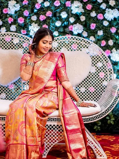 A whimsical shot on a heart-shaped seat. Her soft glam makeup and traditional attire create a beautiful picture.