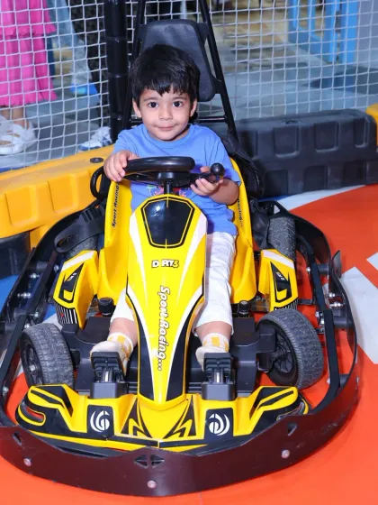 A young boy in a yellow go-kart, ready for action. The easy-to-use controls make it fun for kids of all ages.