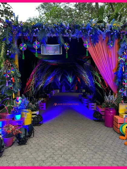 An entrance to a neon dream. This walkway for a Haldi party is designed to be an immersive experience, with colorful lighting and unique props creating a futuristic and fun vibe.