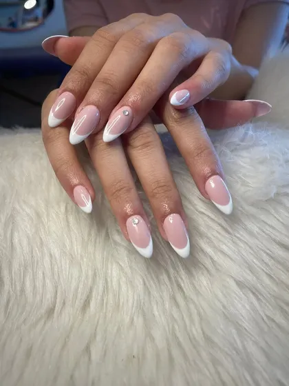 Elegant almond-shaped French manicure with a tiny rhinestone accent for a touch of sparkle.