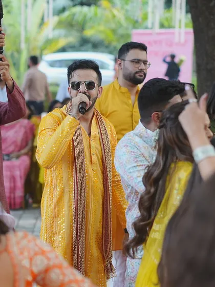 In the midst of the crowd, leading the dance and song during a Haldi function. I make sure the energy is infectious.