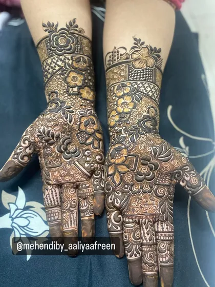 A heavy design featuring floral bands and intricate fillers, covering the hands beautifully.
