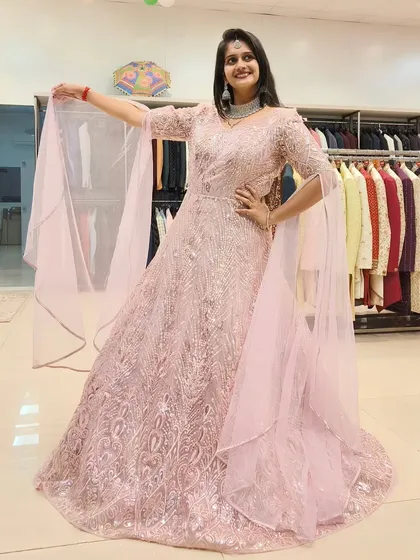 The full look of the pink embroidered gown, showcased in my store. You can see the intricate detail and flattering A-line shape that makes it a popular rental choice.