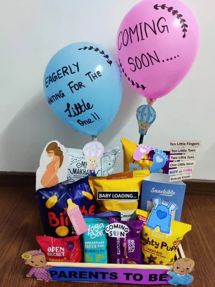 "Eagerly waiting for the little one!" This hamper expresses that excitement with custom balloons and a collection of healthy snacks like makhana and protein bars for the expecting parents.