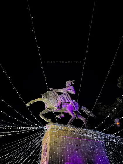 A beautifully lit shot of the Shivaji Maharaj statue at night. This photo highlights the respect and reverence the city holds for its greatest historical icon.