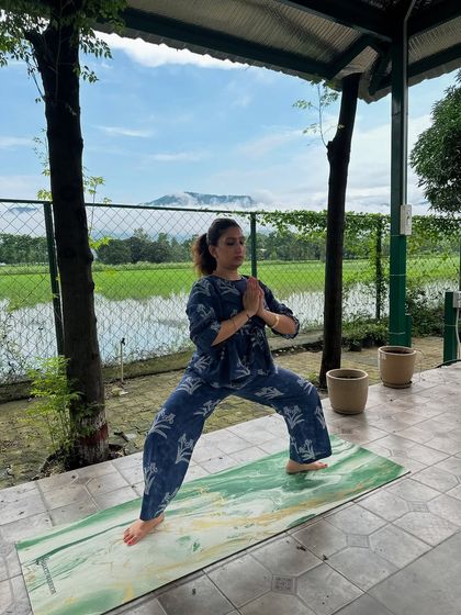 Holding the Goddess Pose with hands in prayer. This posture helps you connect with your inner strength and stability.