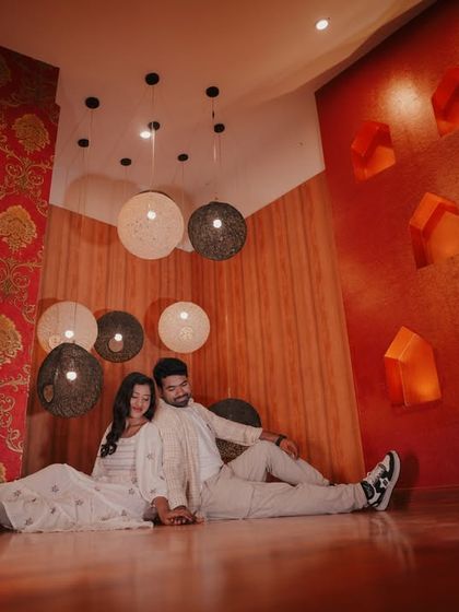 A cozy, relaxed moment for a couple on the floor of our royal room, surrounded by unique hanging lamps.