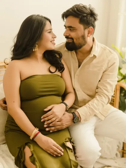 A happy, relaxed moment on our rattan bench during a boho maternity shoot. The couple's easy smiles show how comfortable and at ease they feel in our studio.
