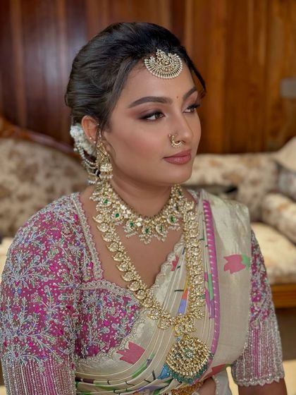 A profile view highlighting the intricate diamond and emerald jewellery and the flawless makeup base.