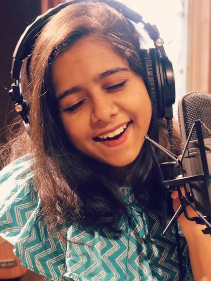 A smile during a recording session. Music brings me immense joy, and I hope to share that feeling with every track I sing on. I believe a happy artist creates heartfelt music.