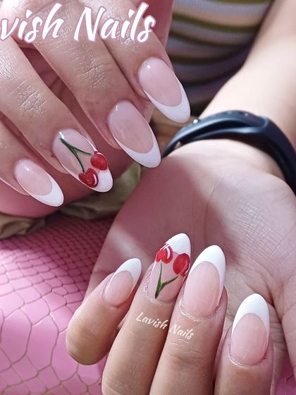 A classic white French manicure on almond nails with a sweet, hand-painted cherry accent nail.