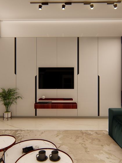 A minimalist media unit with clean white panels and black accents is the focus of this living space. The design includes a low-profile wooden shelf and is complemented by a dark green sofa and nested coffee tables.