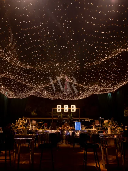 Lighting is my magic wand. For this sangeet, I created an illusion of a starry night sky with a custom canopy of thousands of twinkling fairy lights, transforming the ceiling into a celestial wonder that left guests breathless.