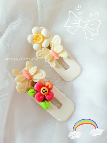 Add a little magic to your look with these adorable handmade hair clips. This pair features a sweet flower and a delicate butterfly in pastel yellow.