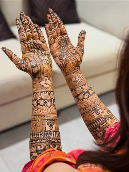 Another angle of the royal-themed bridal mehendi, showing how the design flows from the back of the hand up the arm. The details are crisp and clear.