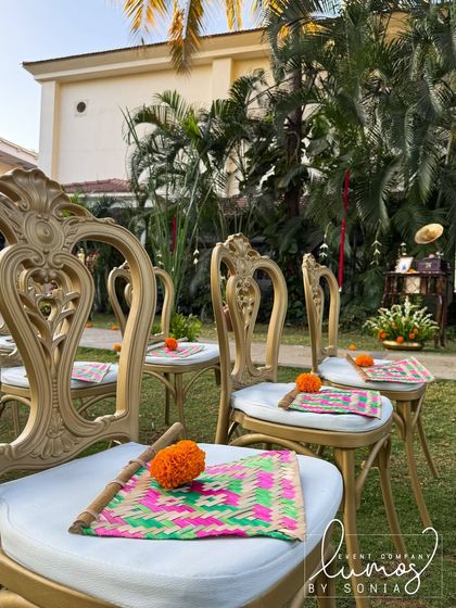 A detailed shot of the traditional hand fans and marigolds placed on the guest chairs, adding a touch of culture and comfort.