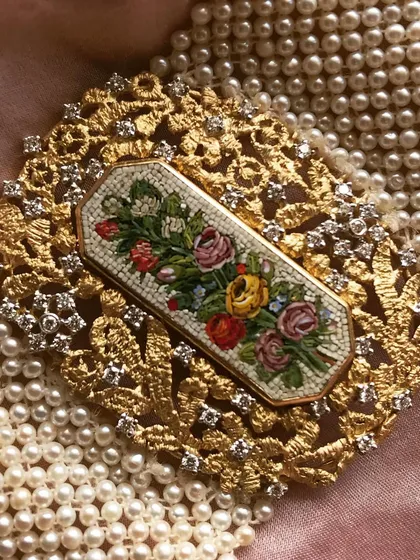 Radhika Ambani wearing a custom sari jewel I created. The micromosaic floral bouquet is set in an ornate 18k gold frame with diamonds, designed to be a timeless heirloom piece.