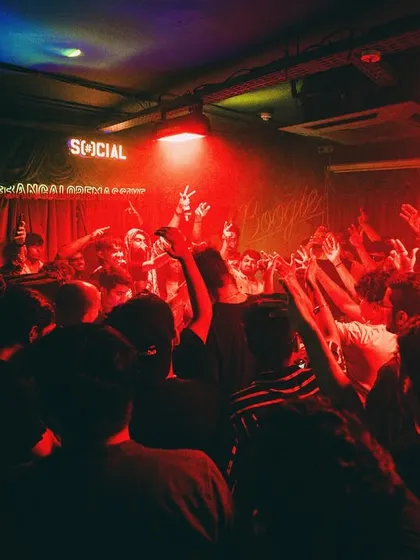 The party is just getting started. A shot of the crowd at a packed club night, with hands in the air, ready for the beat to drop.