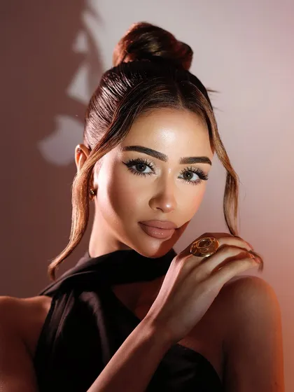 A beautifully lit portrait that enhances the warmth and glow of the makeup.