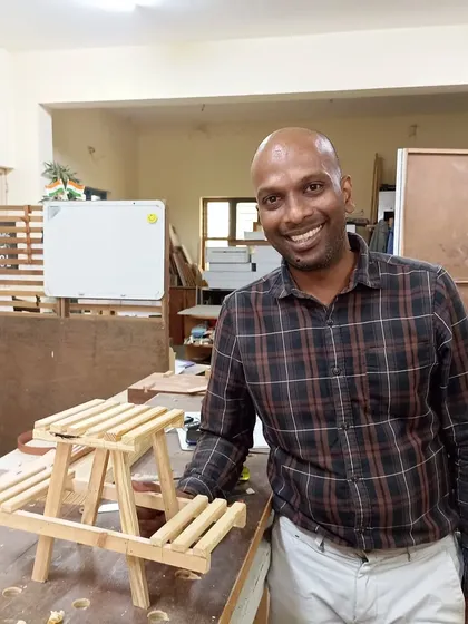 Varun with the scale model of a picnic table he built. This kind of small-scale project is a great way to practice joinery and construction techniques.