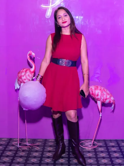 The pink theme is everywhere, from the lighting to the decor. This guest is posing with our pink flamingos and enjoying the free cotton candy.
