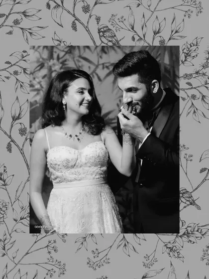 A tender kiss on the hand, framed by a beautiful floral border. This black and white portrait has a vintage, storybook quality to it.
