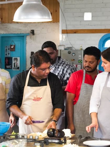 A moment of focused learning during a corporate workshop. Our chef guides the team through the nuances of preparing a dish, ensuring everyone is involved and learning together.