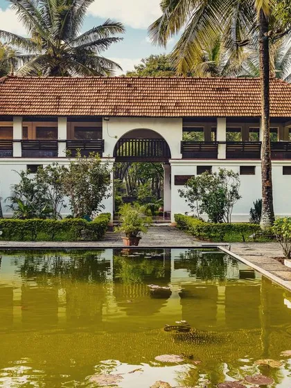 A view of the Padipura and lotus pond, showcasing the vibrant green of our campus. This building is a central point for our guests' wellness activities, offering a peaceful sanctuary for mind-body practices.