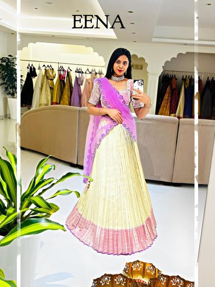 This lehenga is a beautiful blend of soft pastels. A silver and lilac hand-embroidered blouse is paired with an ivory and pink pleated Kanchi silk skirt, creating a look that is both elegant and vibrant.