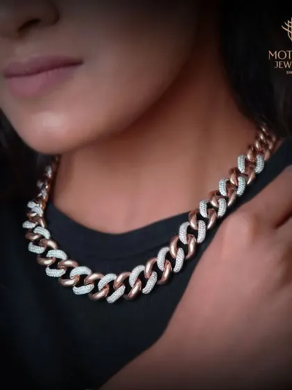Modern luxury with an edge. This bold Cuban link chain necklace is meticulously crafted from rose gold and white gold links, with alternating links fully paved with brilliant-cut diamonds. It is a versatile statement piece that blends contemporary style with our legacy of fine jewellery making.