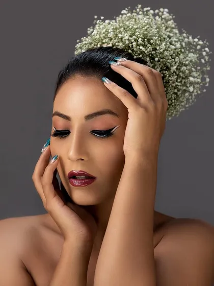 A beautiful beauty portrait with a model wearing a crown of baby's breath flowers in her hair.