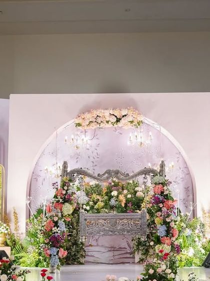 A full view of the dreamy stage we set for Inara's naming ceremony. The pastel color palette, combined with the elegant silver cradle and floral-printed backdrops, created a scene of pure enchantment.