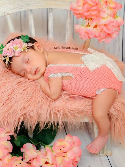 A beautiful floral theme in shades of pink. The baby sleeps peacefully on a miniature chair, adorned with a floral headband and surrounded by soft petals, creating a sweet and delicate portrait.