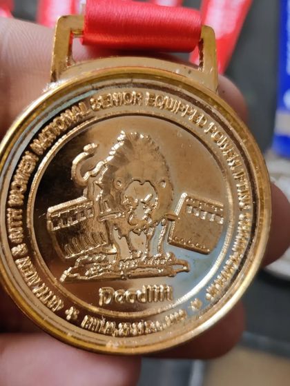 A close-up of my deadlift gold medal from the 2022 Senior Nationals.