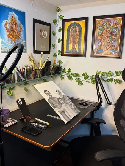 A view of my workspace. This is where I spend hours creating sketches and paintings, surrounded by my tools and completed artworks.
