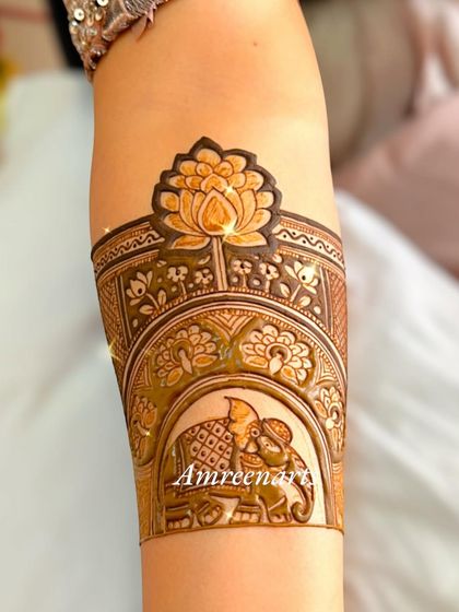 A beautiful arm band featuring a lotus flower and an elephant in a howdah.
