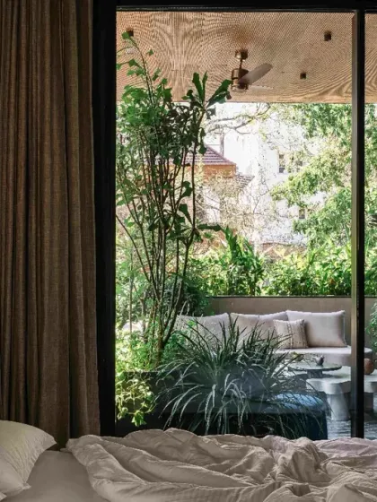 A view from a bedroom in Project 1374, where private spaces are designed as quiet cocoons. A large sliding glass door opens onto a private court, ensuring a constant connection to nature while maintaining seclusion.