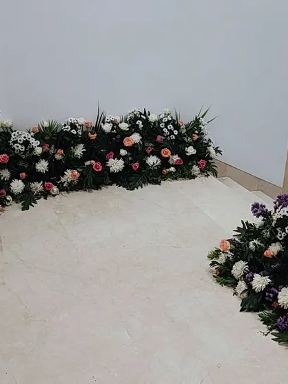 A ground-level view of the staircase decor, showing how the floral runners guide guests up to the main event area.