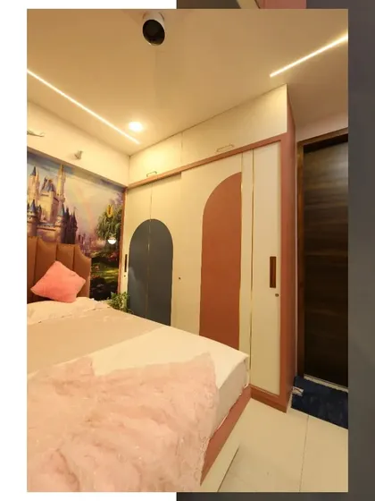 The wardrobe in the princess-themed room features a playful arch design in pink and blue, offering ample storage while perfectly matching the room's whimsical aesthetic.