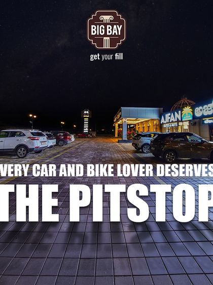 A wide-angle night shot of our parking area, dedicated to the car and bike lovers who deserve a pitstop that caters to all their needs.