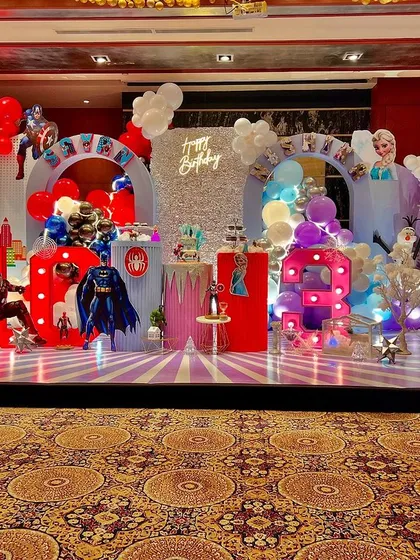 This is what happens when two worlds collide for a joint birthday party. I designed a magical fusion theme, combining the action of superheroes for a 'man in the making' and the icy elegance of Frozen for a 'diva', ensuring both birthday stars felt celebrated in their own unique way.
