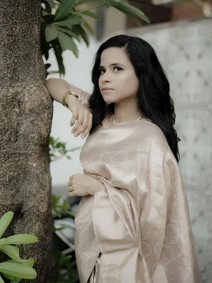 A thoughtful portrait of a woman in a beautiful silk saree, her expression conveying a sense of calm and grace.